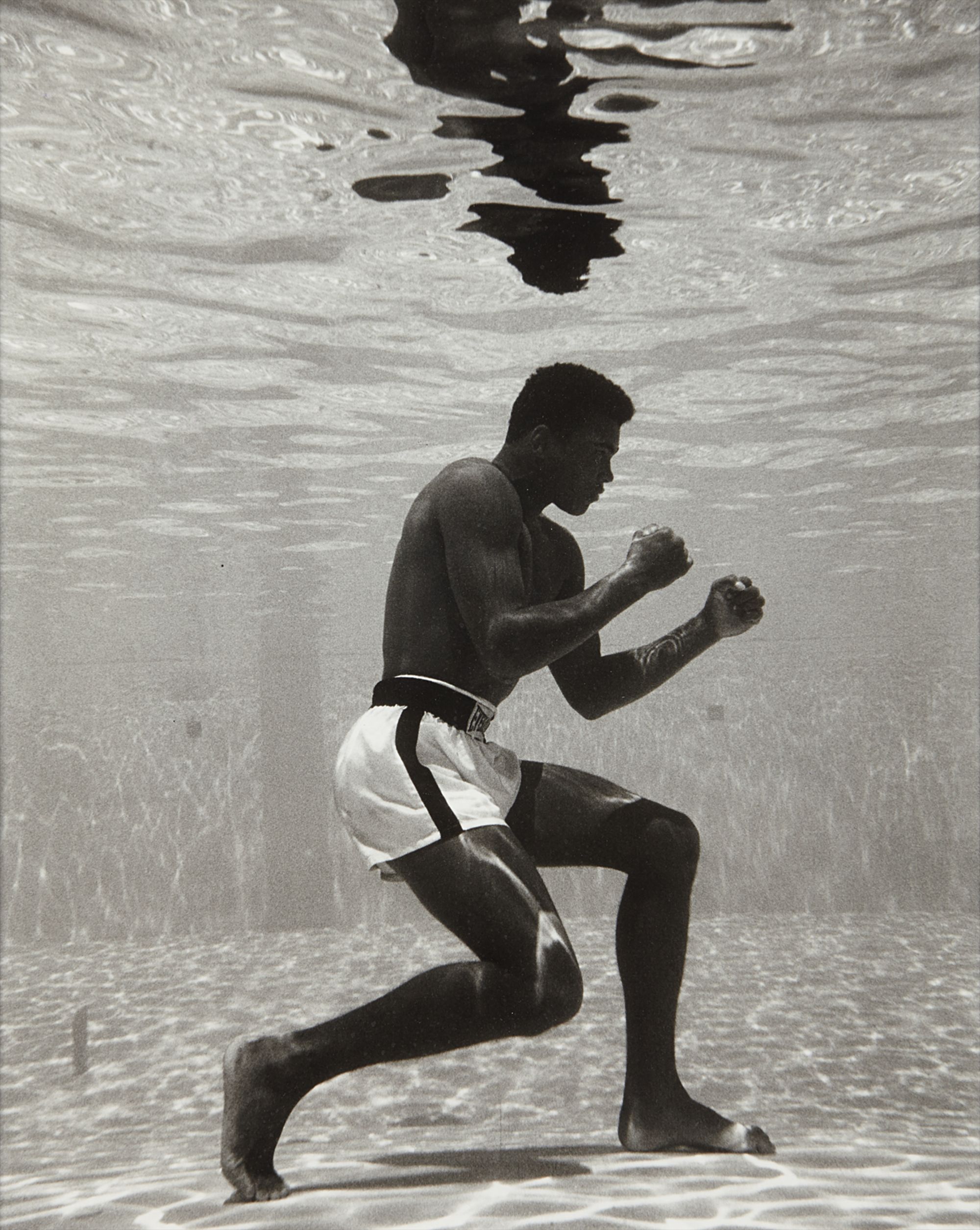 Flip Schulke — Muhammad Ali boxing underwater