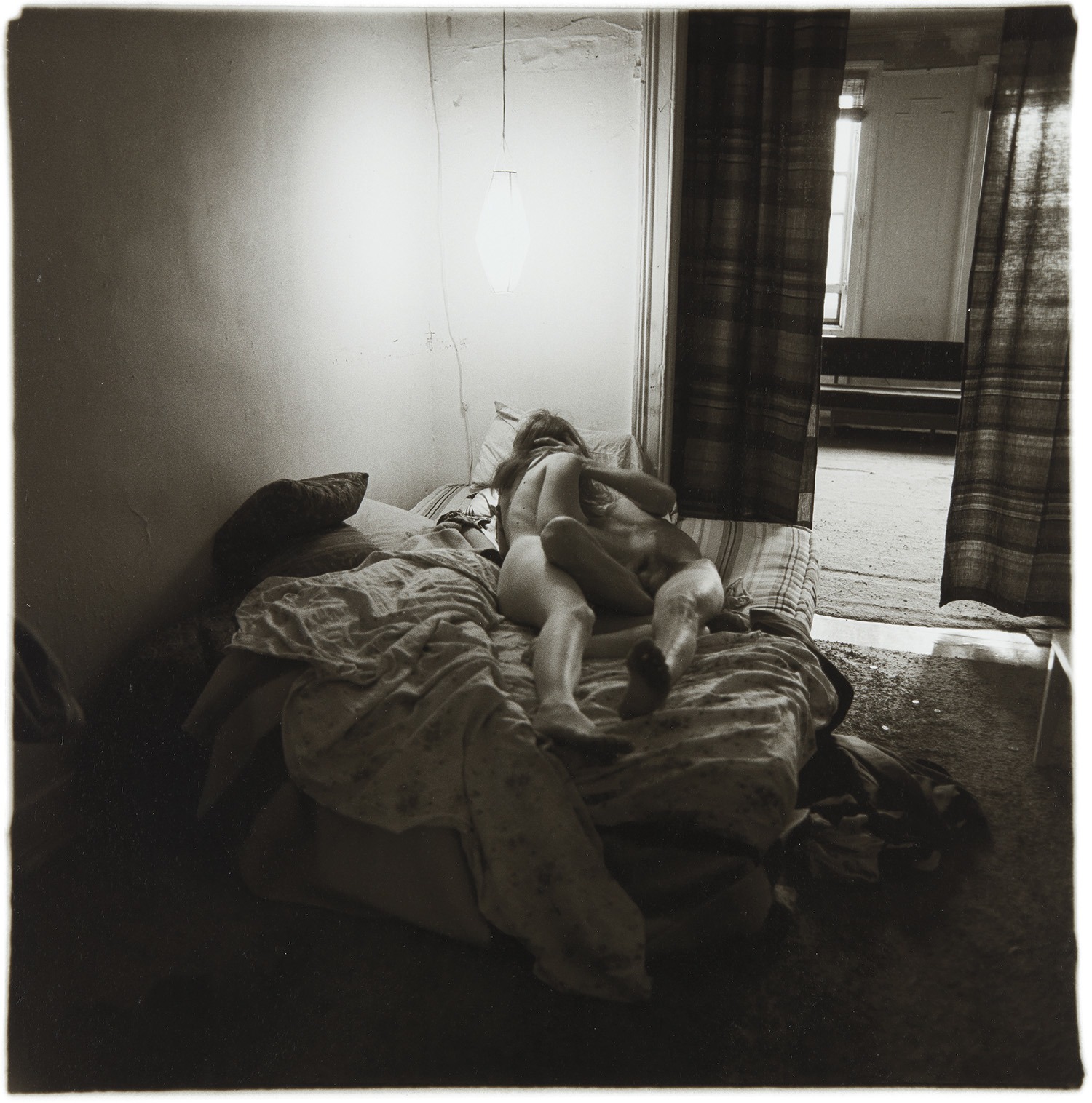Diane Arbus — Couple in bed under paper lantern, N.Y.C.