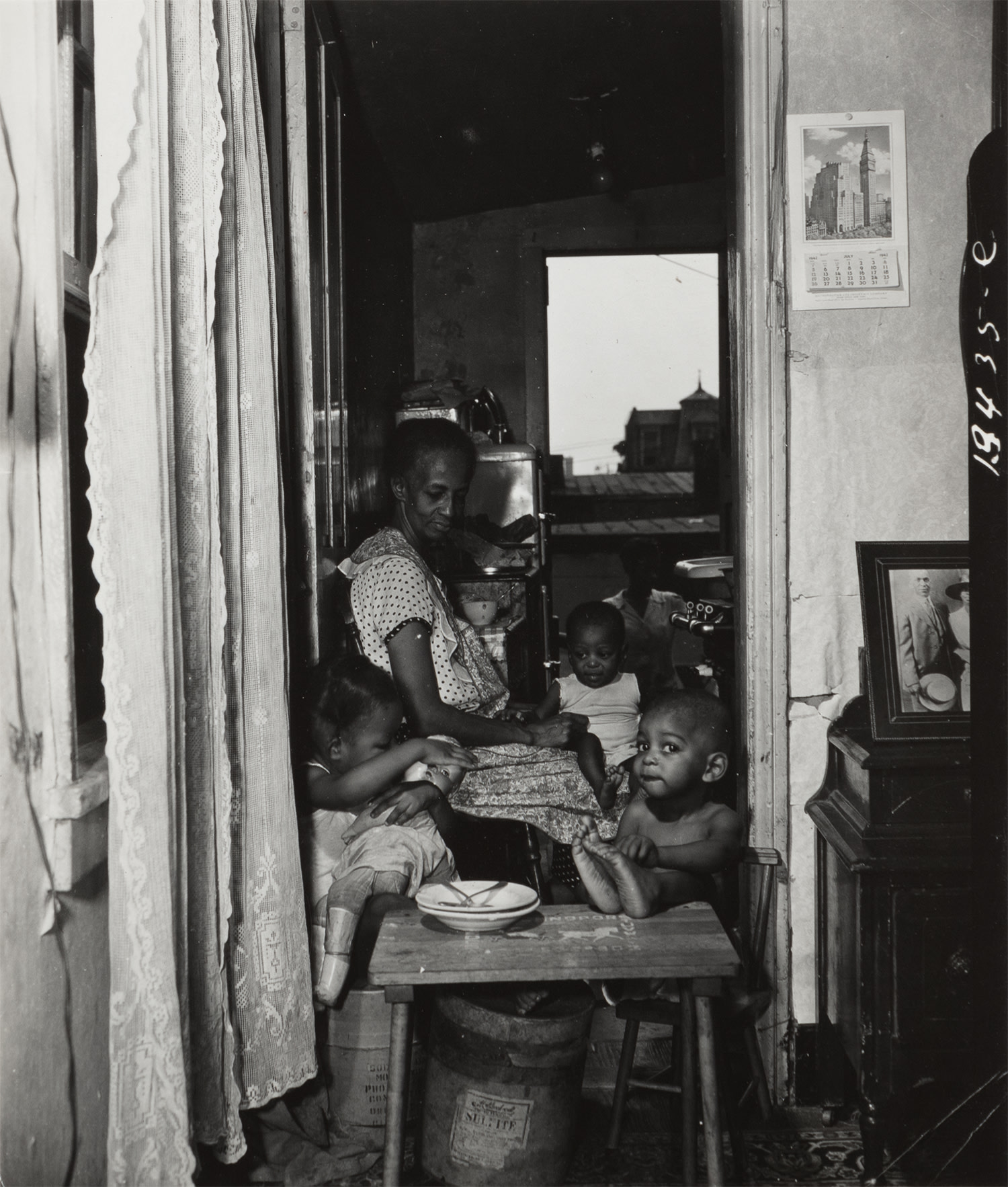 Mrs. Ella Watson with three grandchildren and her adopted daughter, July