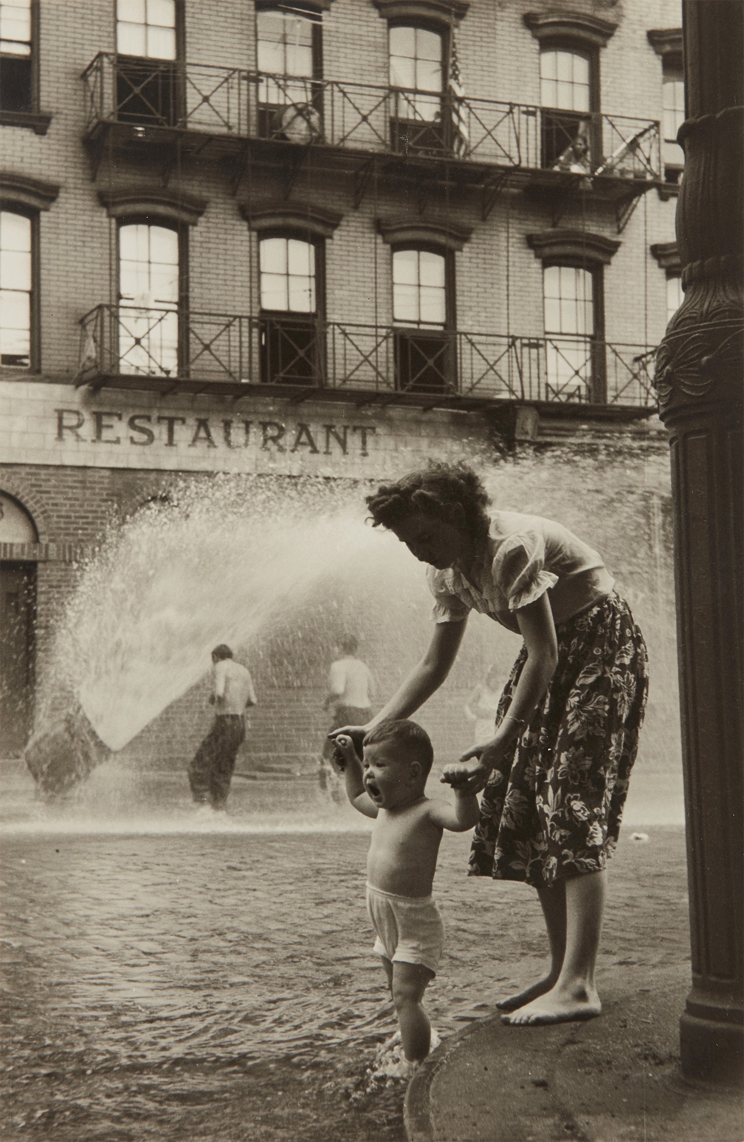 Ruth Orkin — Fire Hydrant (mother and child)