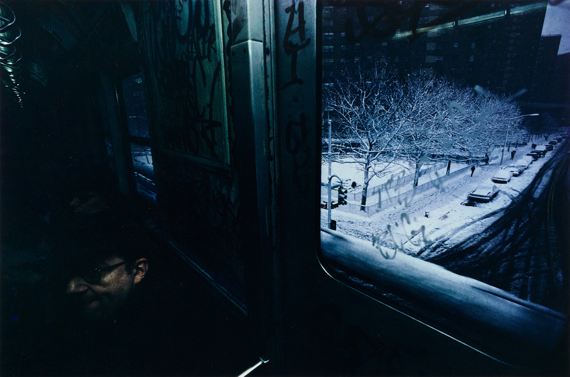 Bruce Davidson — Man on Train, Snowy Street from Subway
