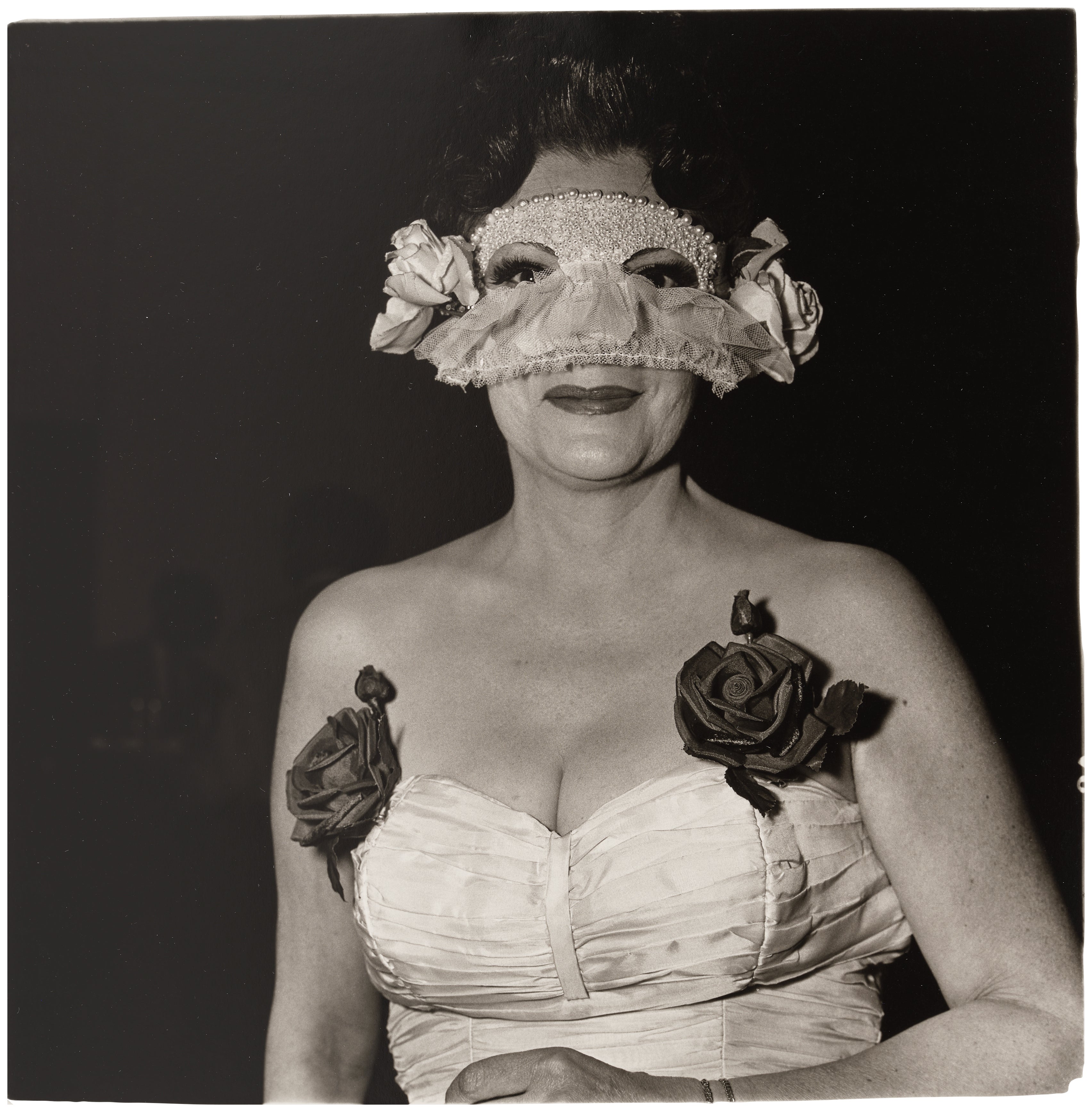 Diane Arbus — Lady at a Masked Ball with Two Roses in Her Dress, NYC