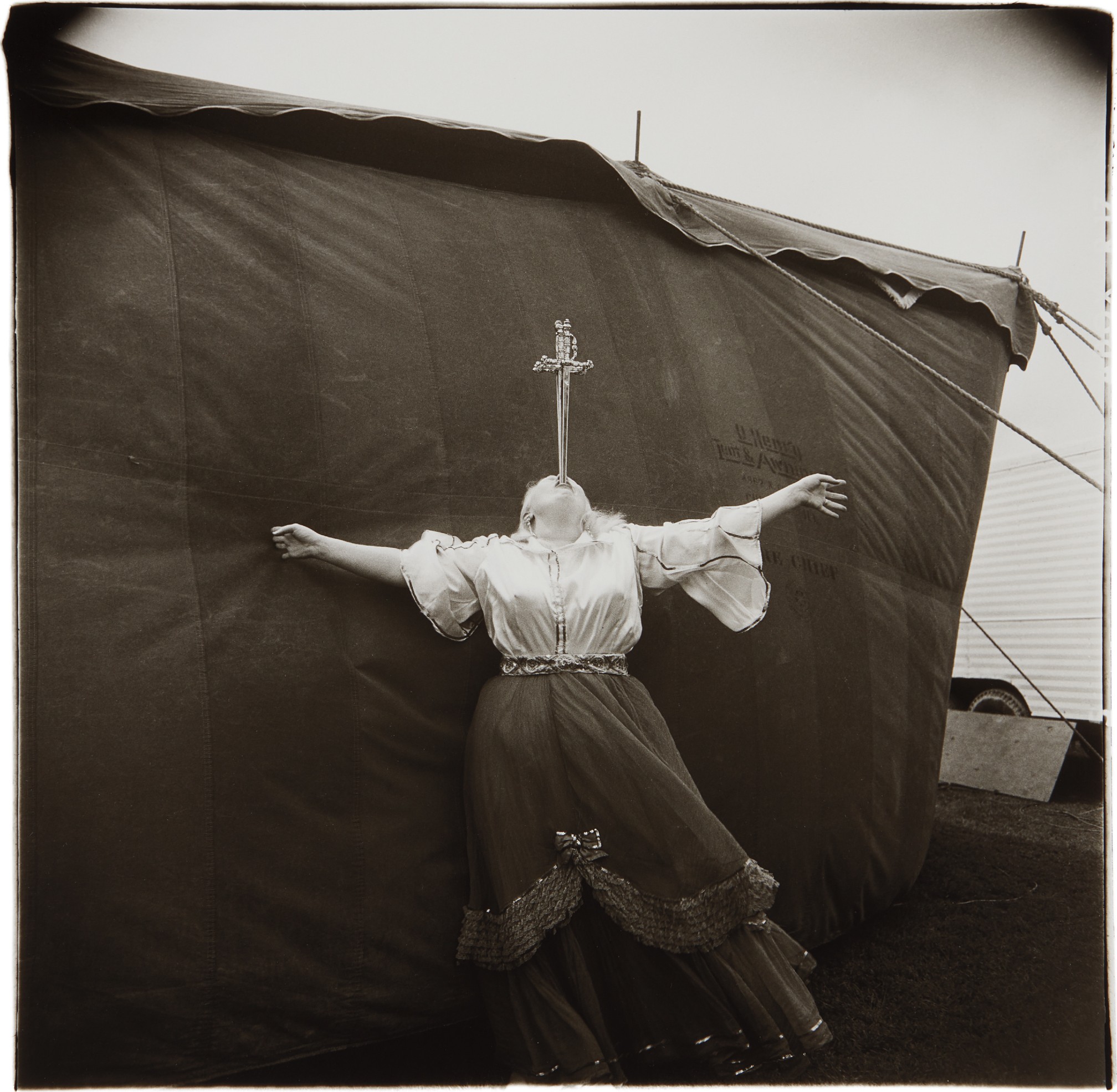Diane Arbus — Albino Sword Swallower at a Carnival, MD.