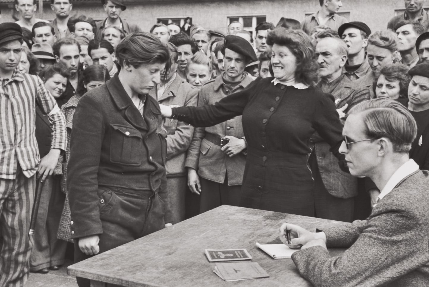 Henri Cartier-Bresson — Gestapo informer recognized by a woman she had denounced, Transit Camp, Dessau, Germany