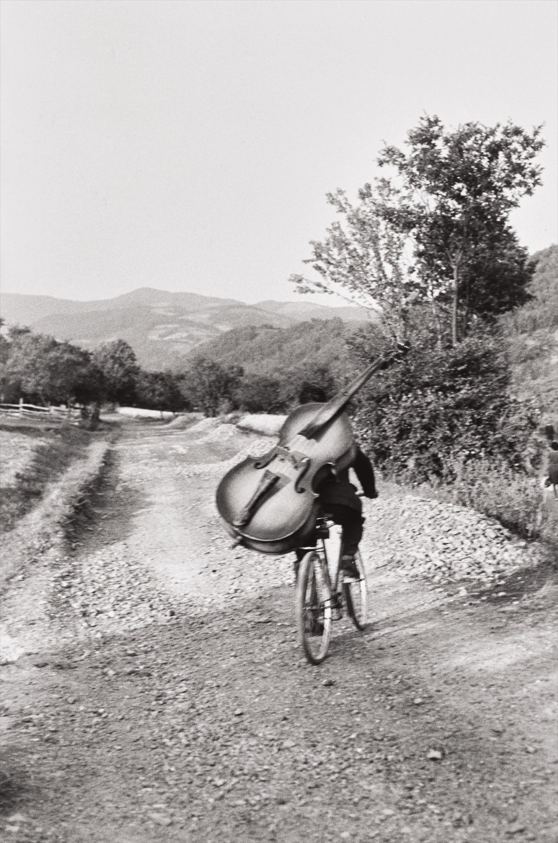 Henri Cartier-Bresson — Bass player on the road Belgrade-Kraljevo, to play at a village festival near Rudnik, Serbia, Yugoslavia