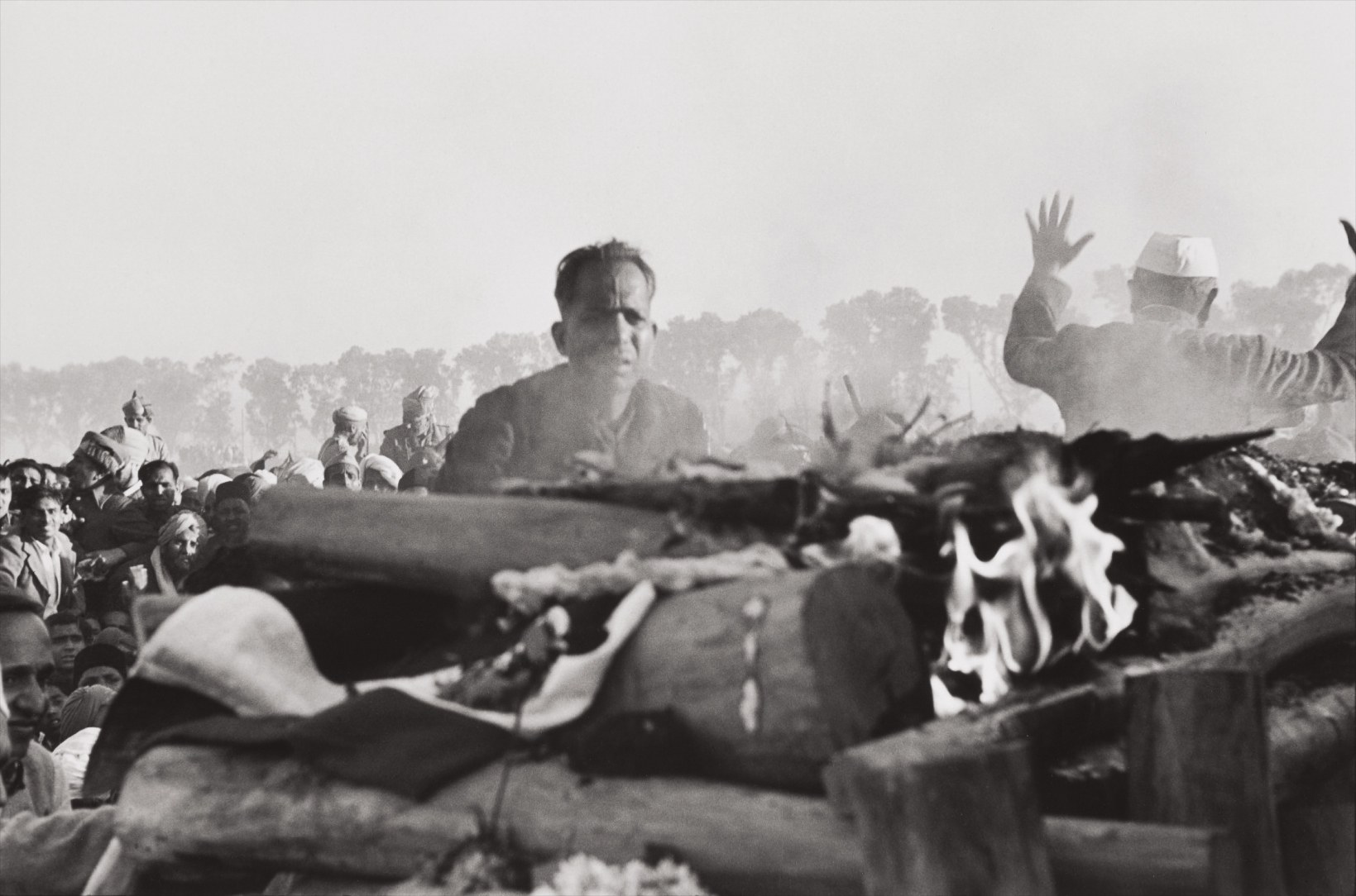 Henri Cartier-Bresson — Gandhi's secretary watches the first flames of the funeral pyre, Delhi, India