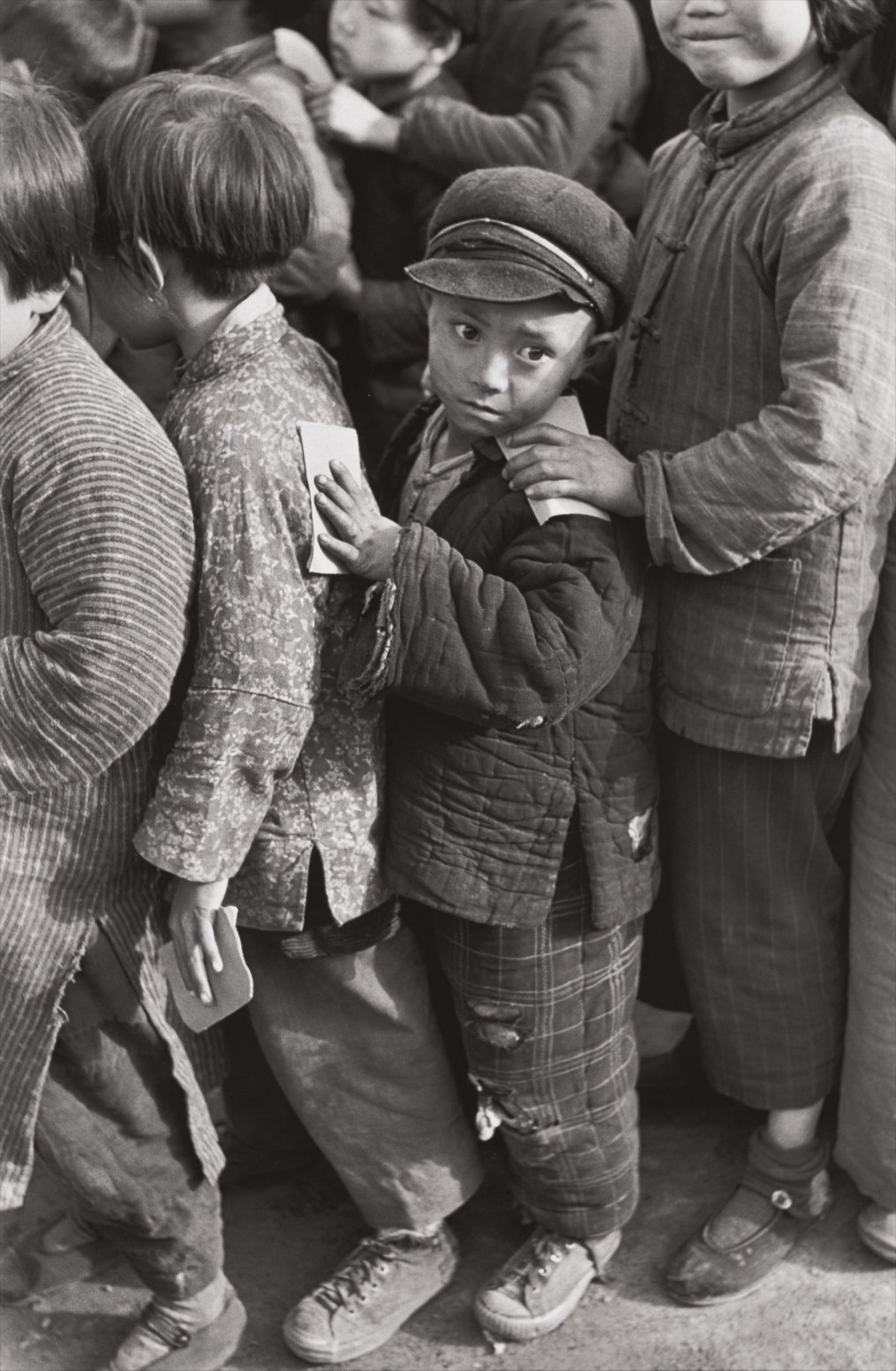 Henri Cartier-Bresson — Children await rice distribution, Shanghai, China