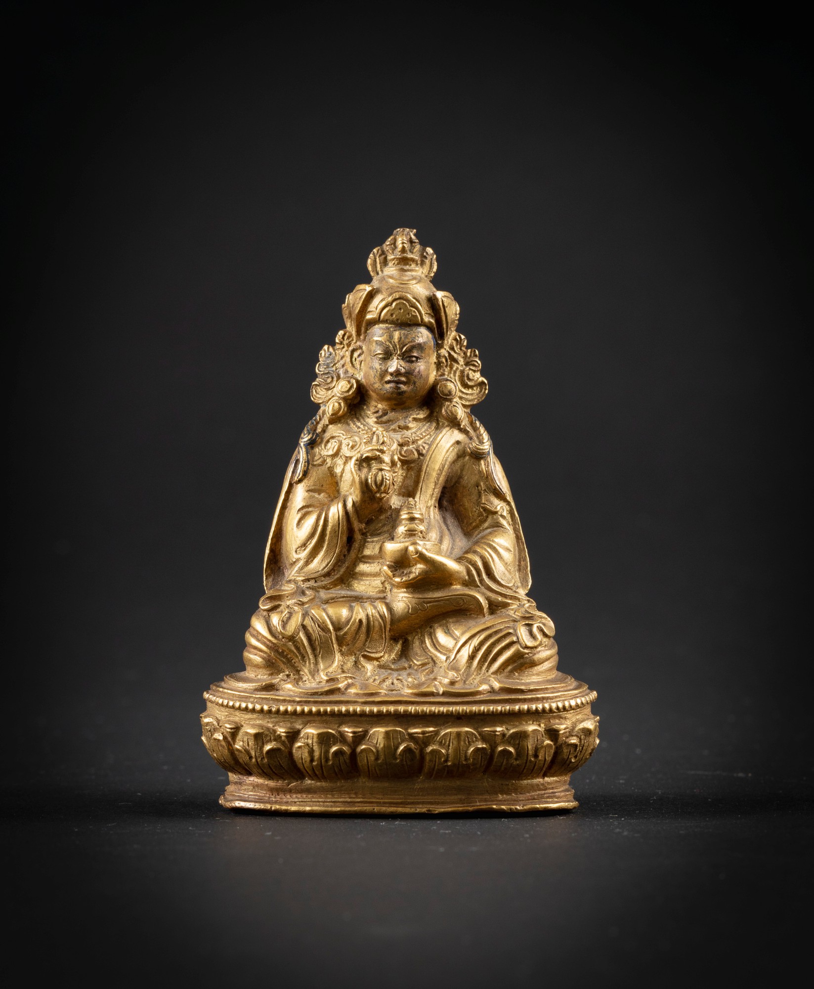 A gilt-copper alloy Padmasambhava — 西藏 十九世紀 鎏金銅合金蓮花生大師坐像