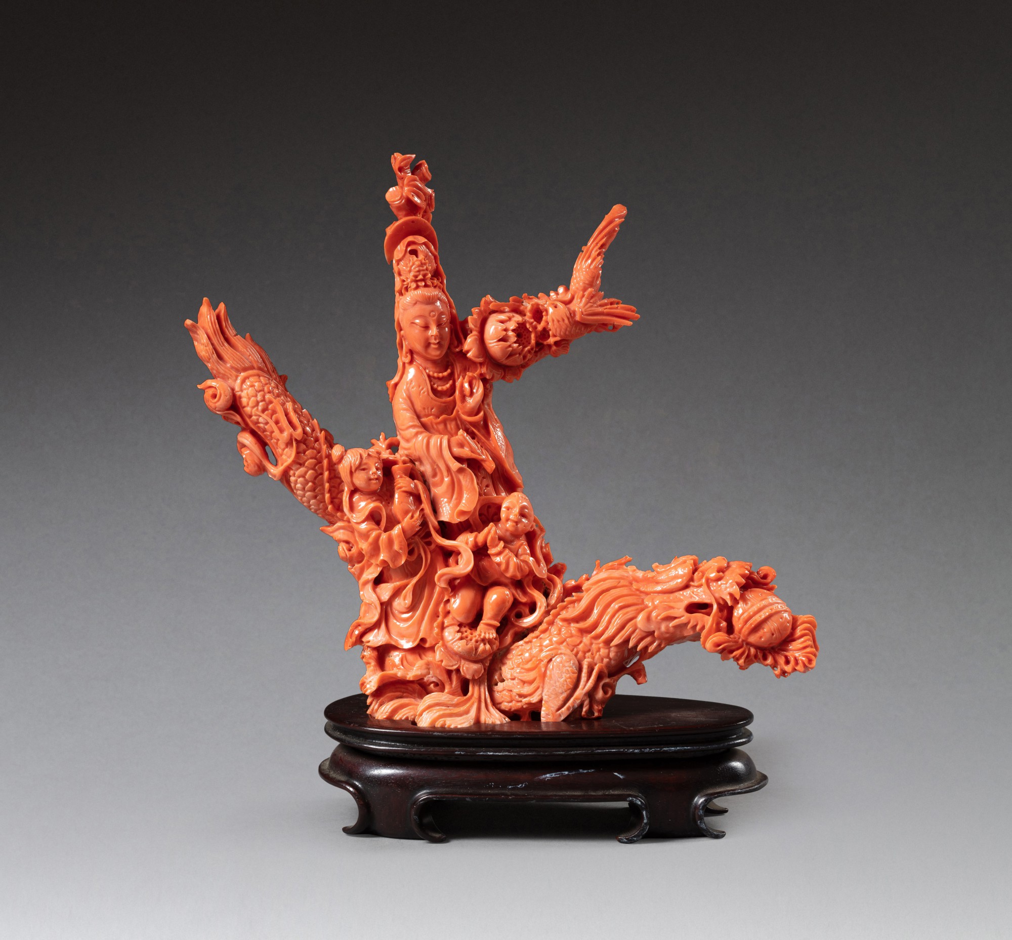 A carved coral figure of Guanyin riding on dragon — 民國 紅珊瑚雕乘龍觀音像