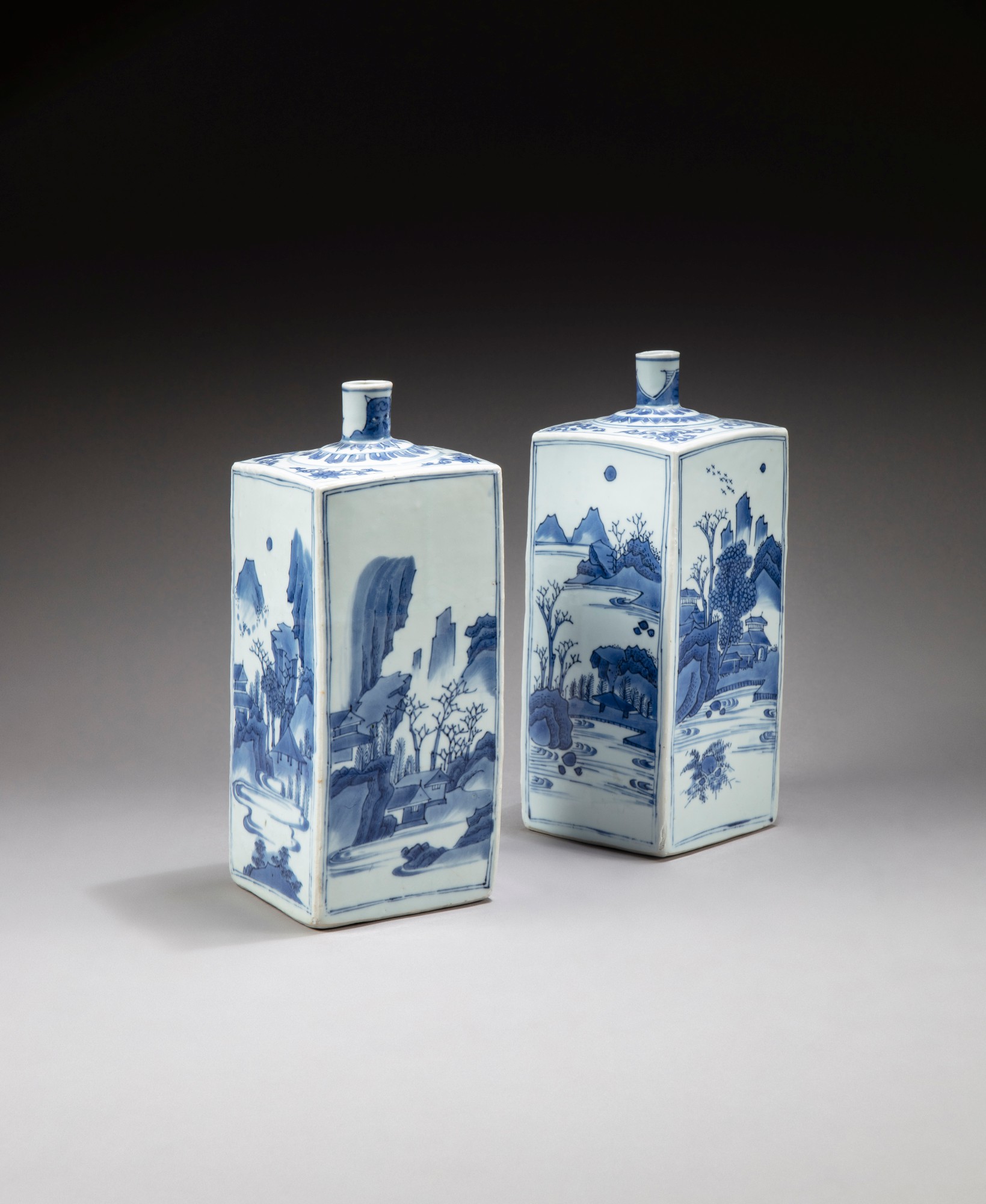 Two blue and white square 'landscape' bottle vases — 明末清初 青花山水紋方瓶一組兩件