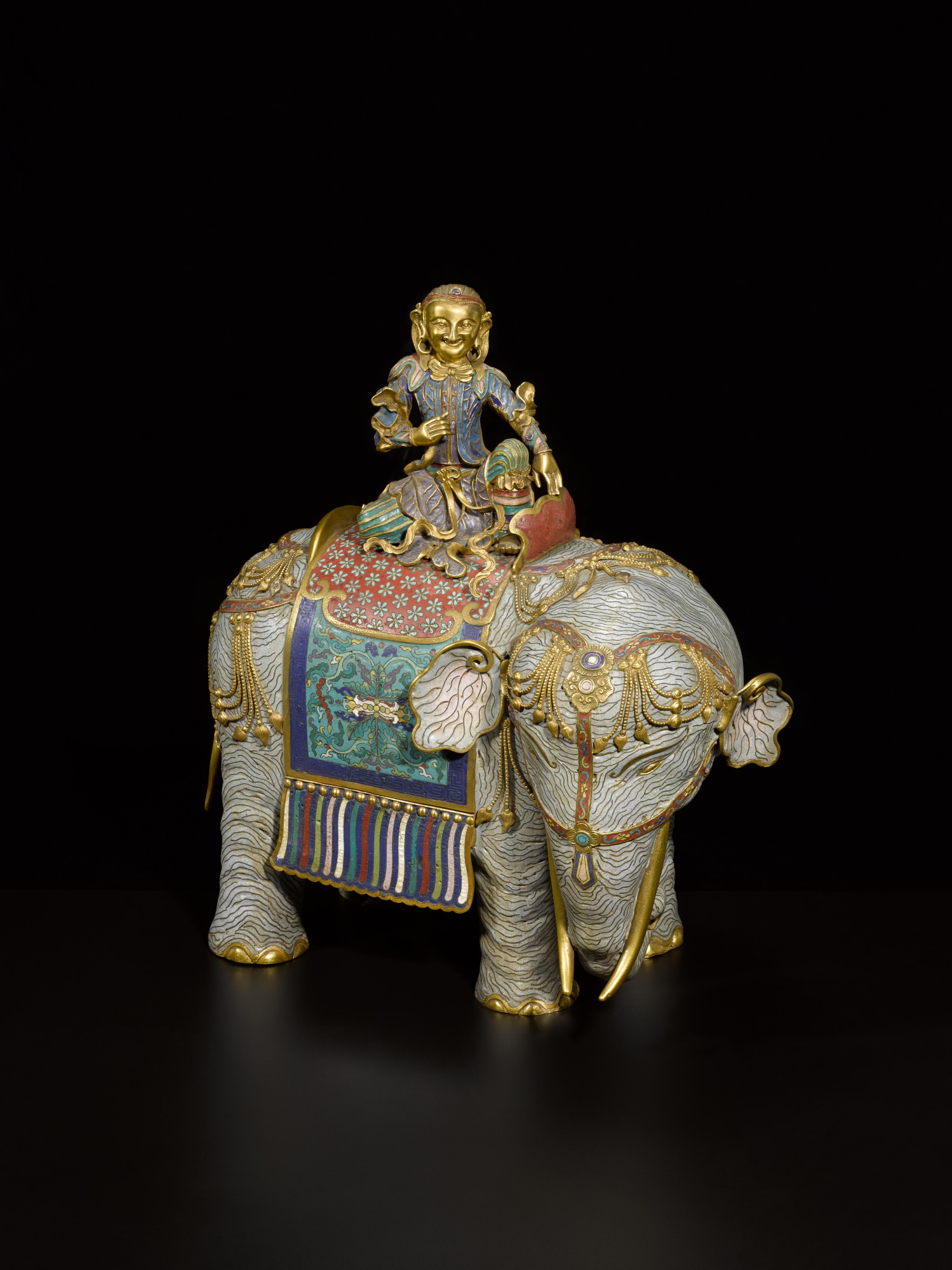 An exceptional gilt-bronze and cloisonné enamel caparisoned elephant — 清乾隆 掐絲琺瑯胡人騎象擺件
