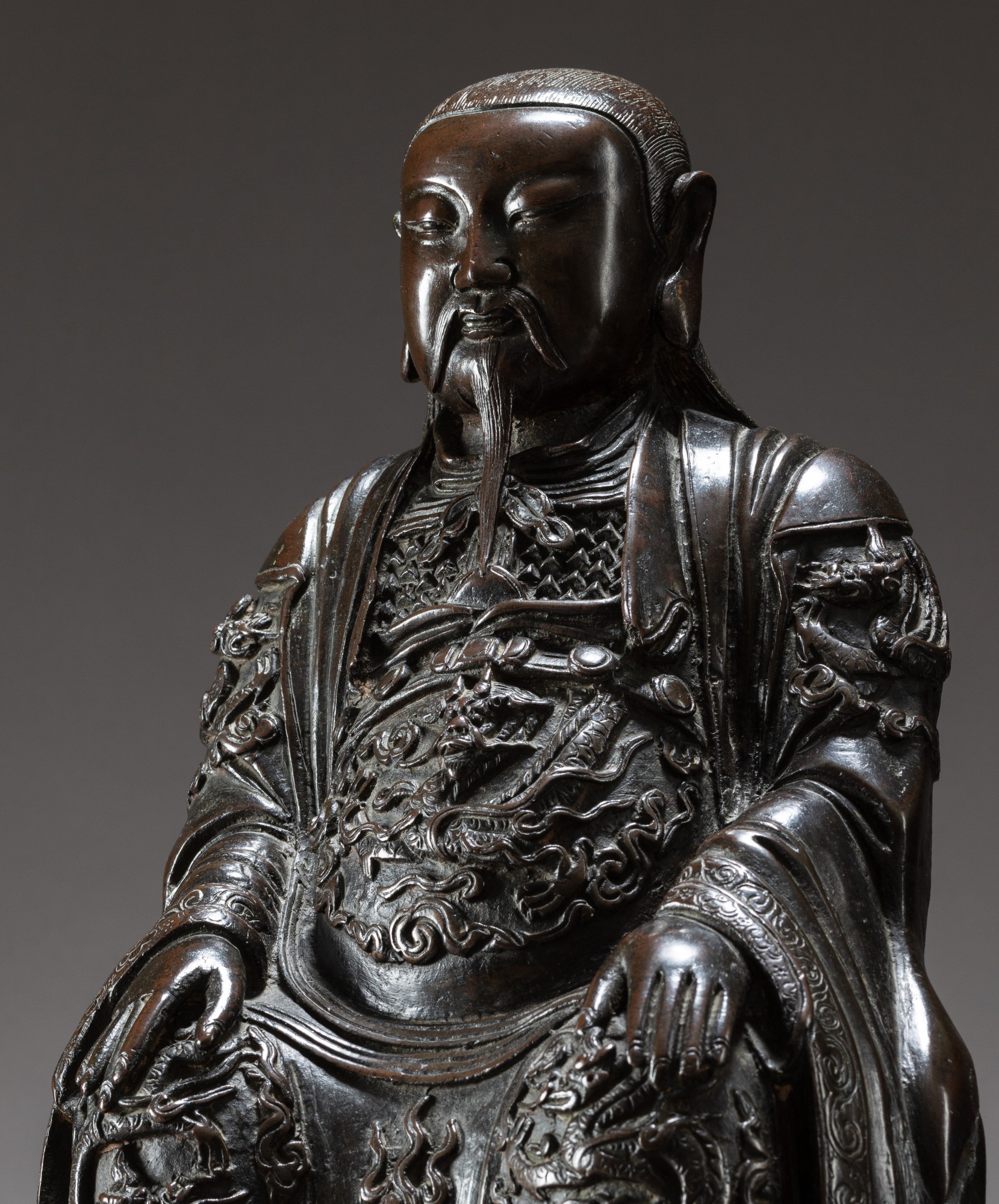 A bronze figure of a guardian King — 明十七世紀 銅天王坐像