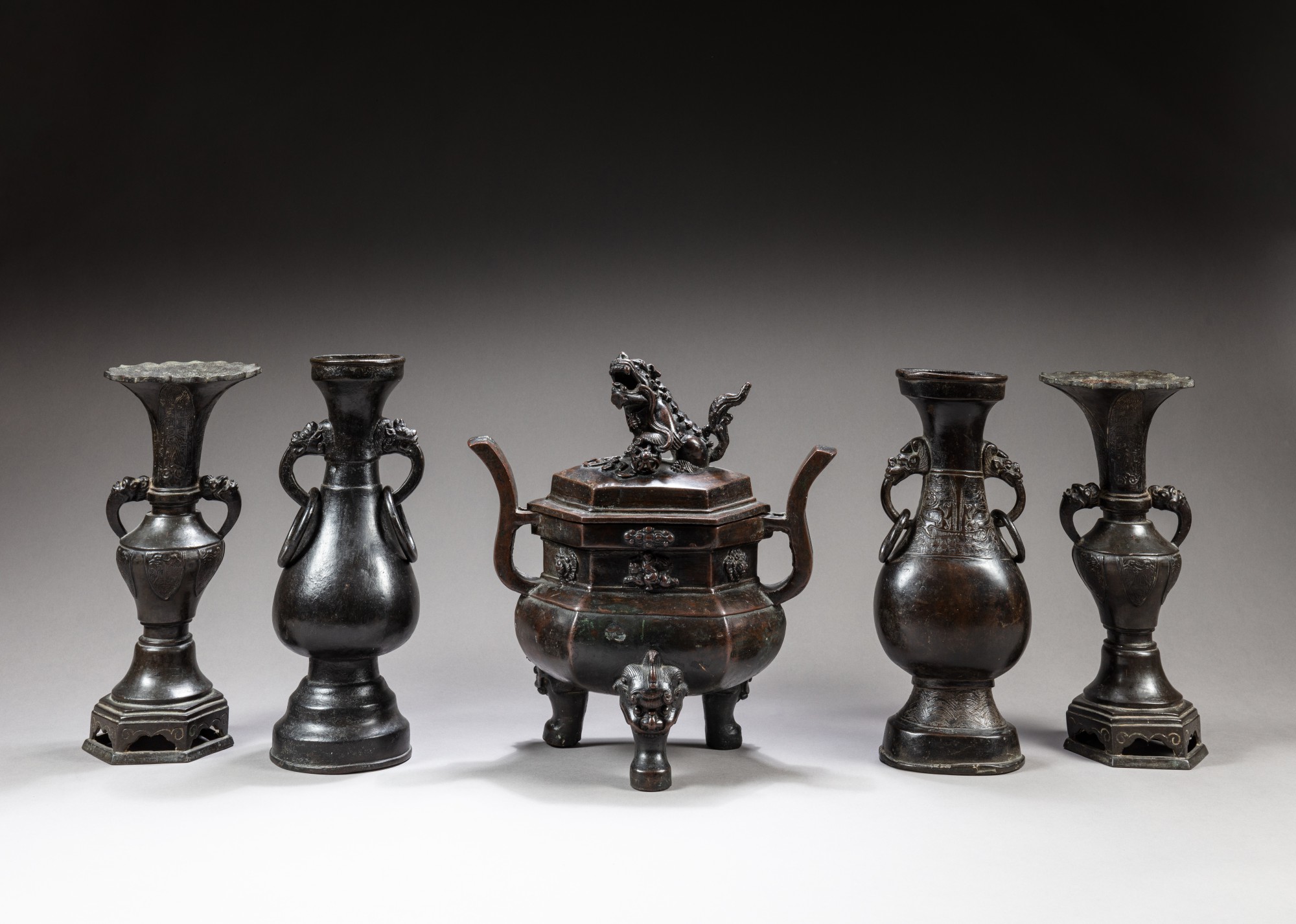 A garniture of five bronze altar vases — 明十六至十七世紀 銅獅鈕三足爐及雙耳瓶一組五件