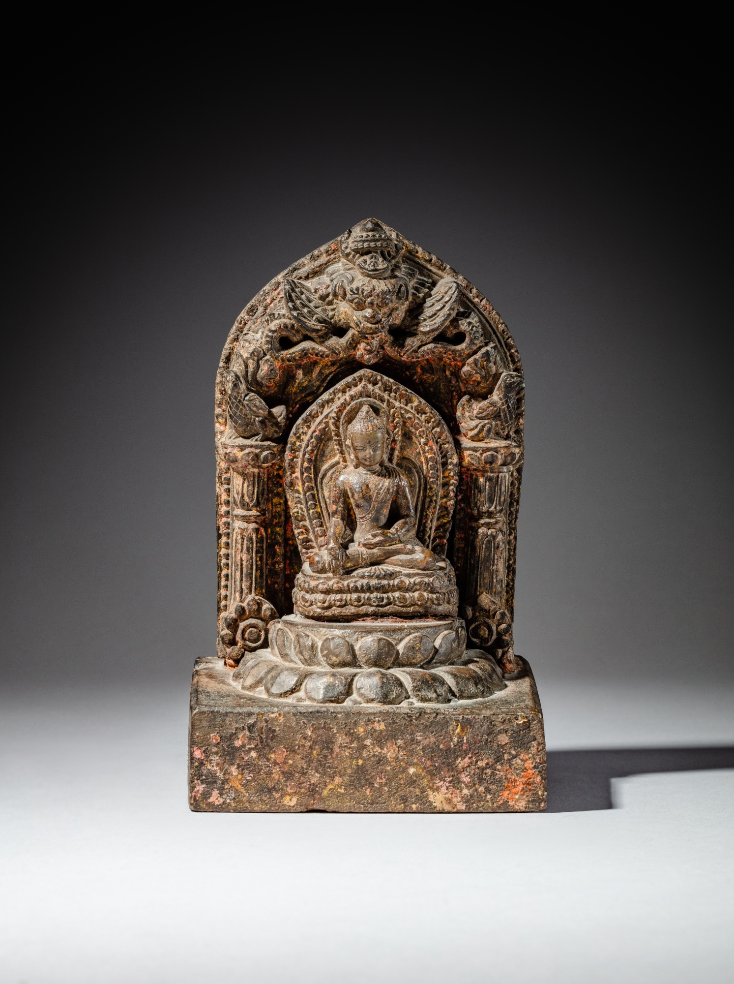 A stone seated figure of a Buddha — 尼泊爾 約十四至十五世紀 石雕佛坐像