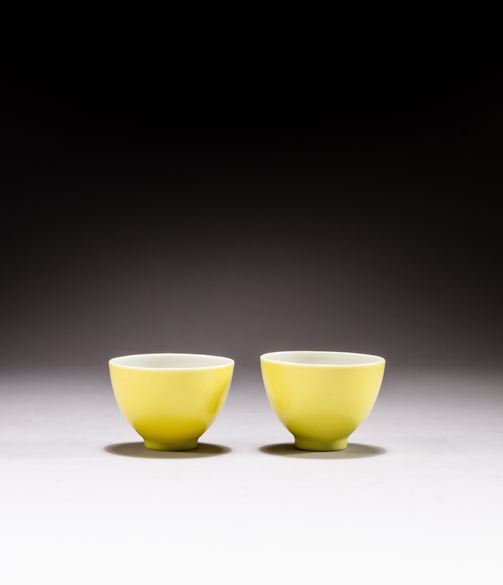 A pair of lemon yellow-glazed cups — 清雍正 檸檬黃釉小盃一對 《大清雍正年製》款