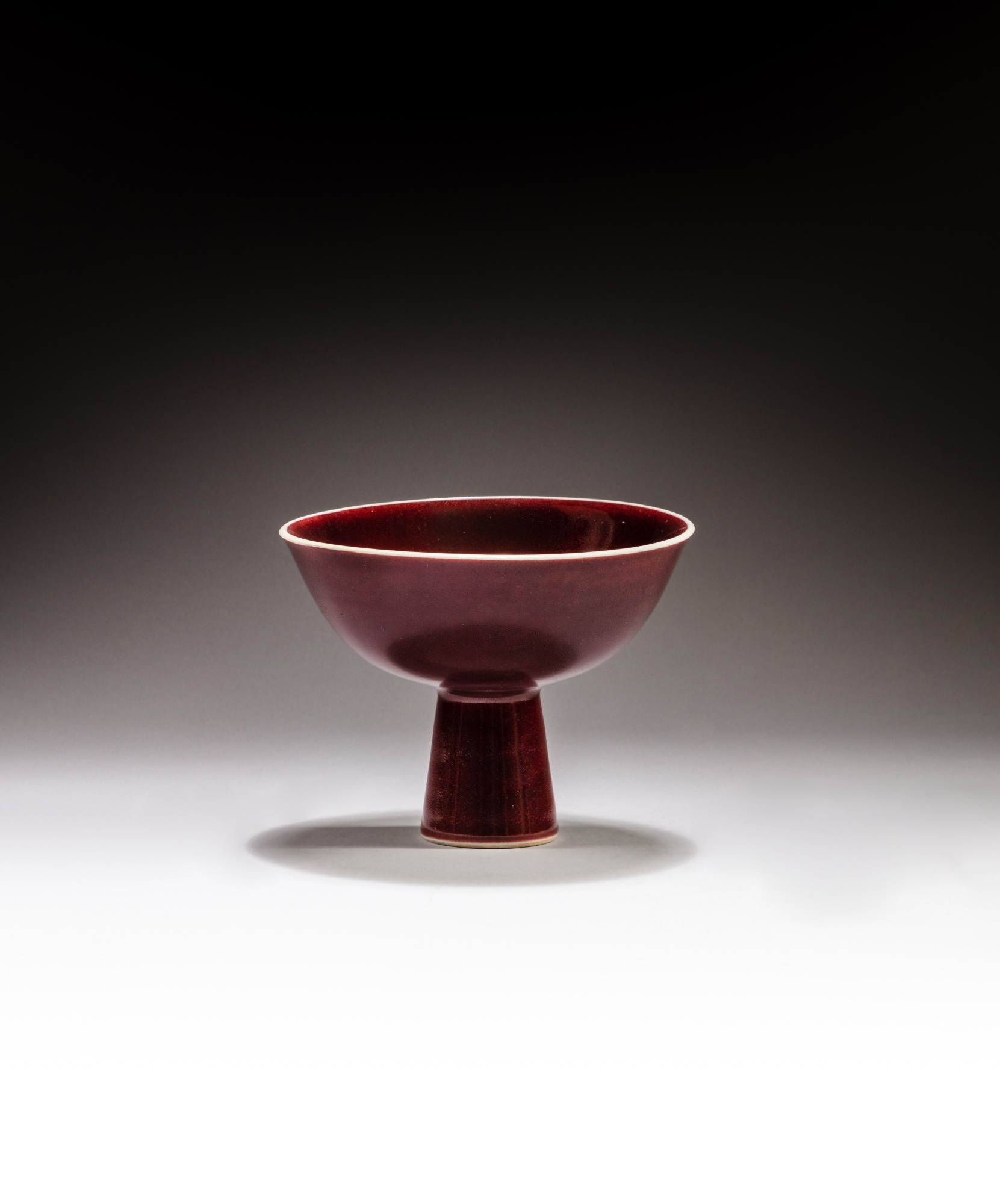 A copper red-glazed stemcup — 清乾隆 紅釉高足盃《大清乾隆年製》款
