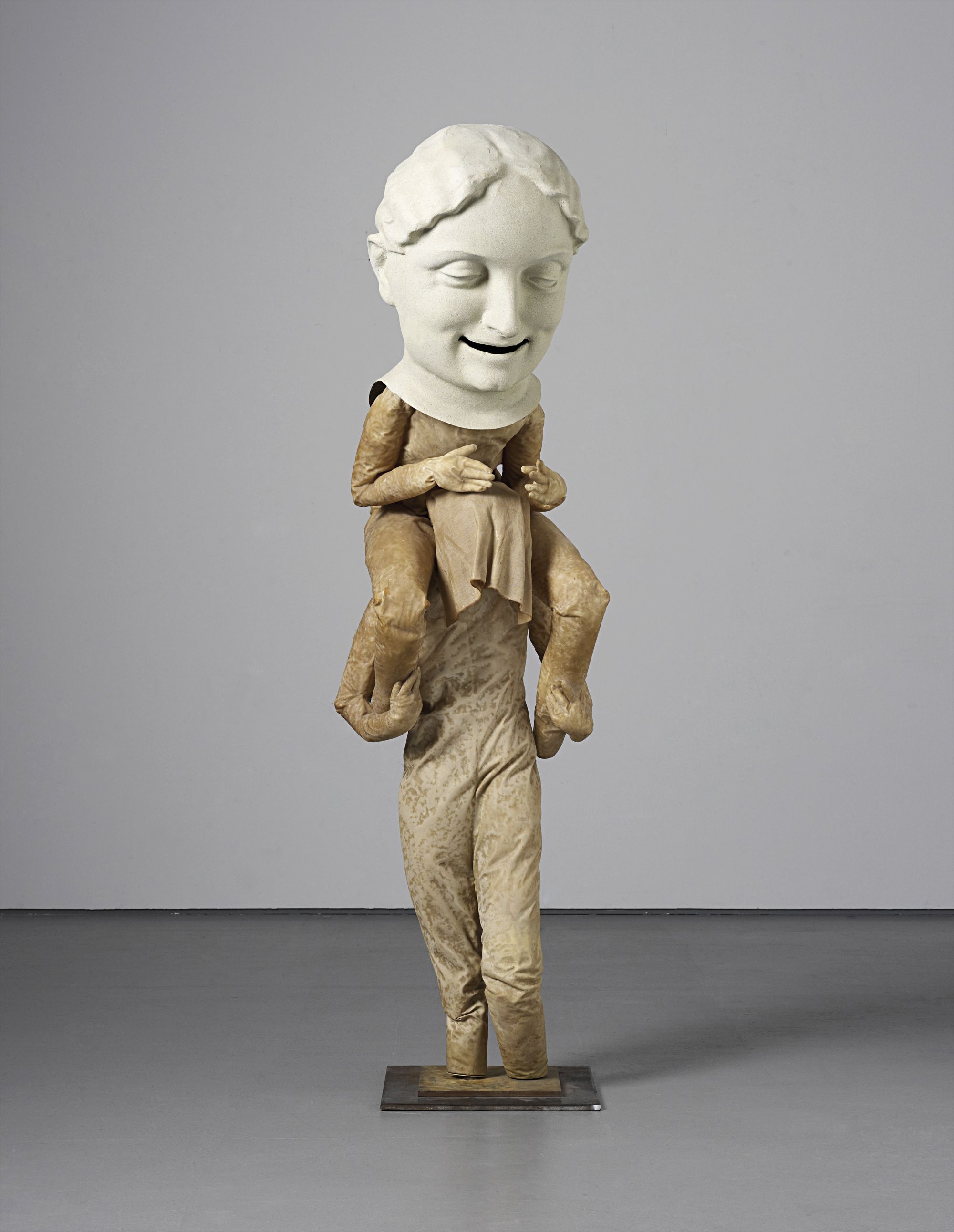 The fgurative sculptures of Spanish artist Juan Muñoz, who is a self-acknowledged storyteller, combine a personal exploration of human experience with a theatricality, synthesizing an emotional calm with the cerebral. Size plays a key conceptual role in all of Muñoz’s sculptures, as the slightly smaller than life-size fgures isolate themselves from the spectator, creating a sense of exclusion from the viewer. However, the present lot carries with it a unique sense of vertical scale, featuring one fgure on the shoulders of another.