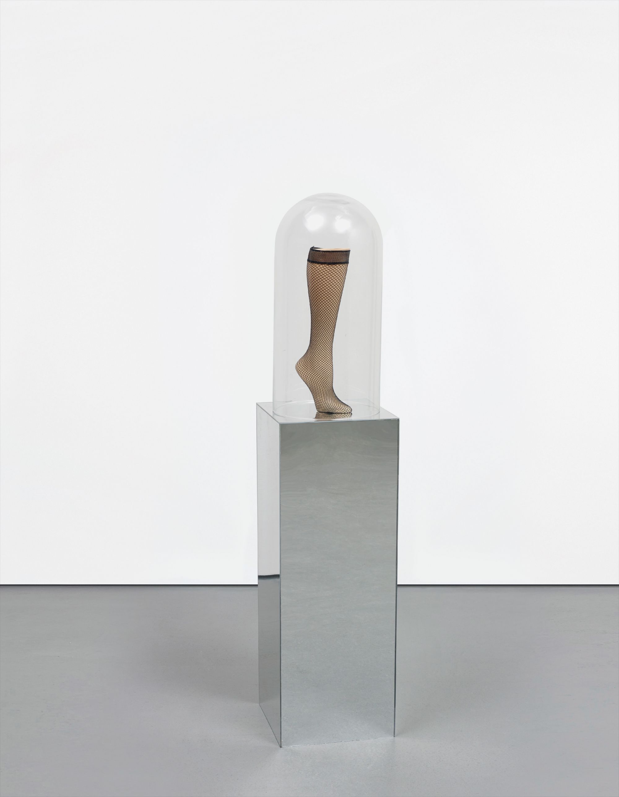 mannequin leg in hosiery, glass dome on artist's plinth