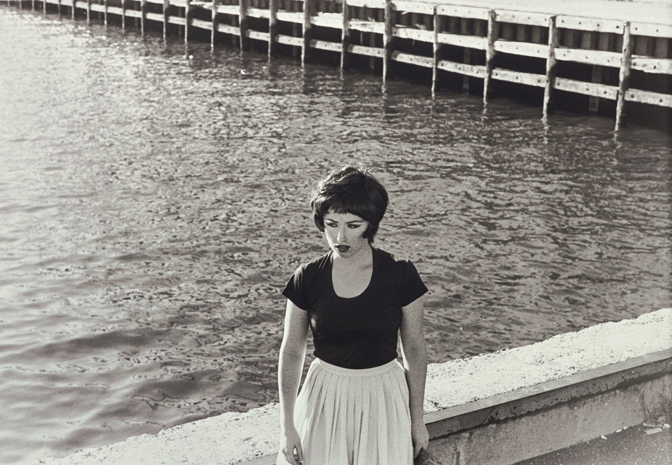 Cindy Sherman — Standing expressionless against the edge of a bridge, the protagonist from