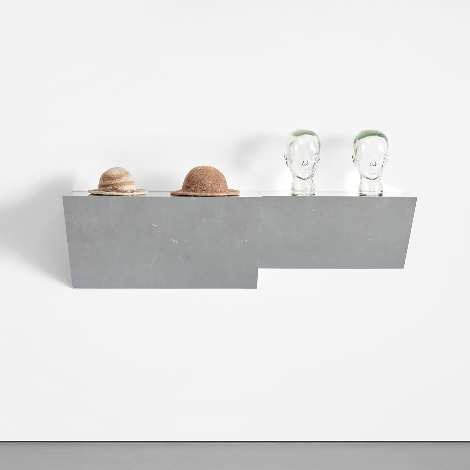 Haim Steinbach — chrome laminated wood shelf, 2 felt hats and 2 glass heads