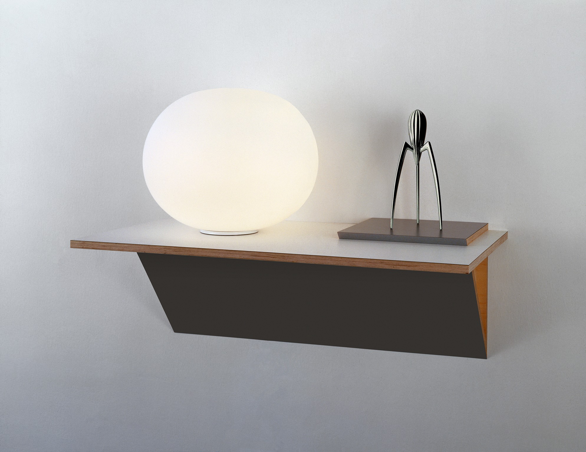 Haim Steinbach — plastic laminated wood shelf, glass Glo-ball lamp and metal Juicy Salif citrus squeezer