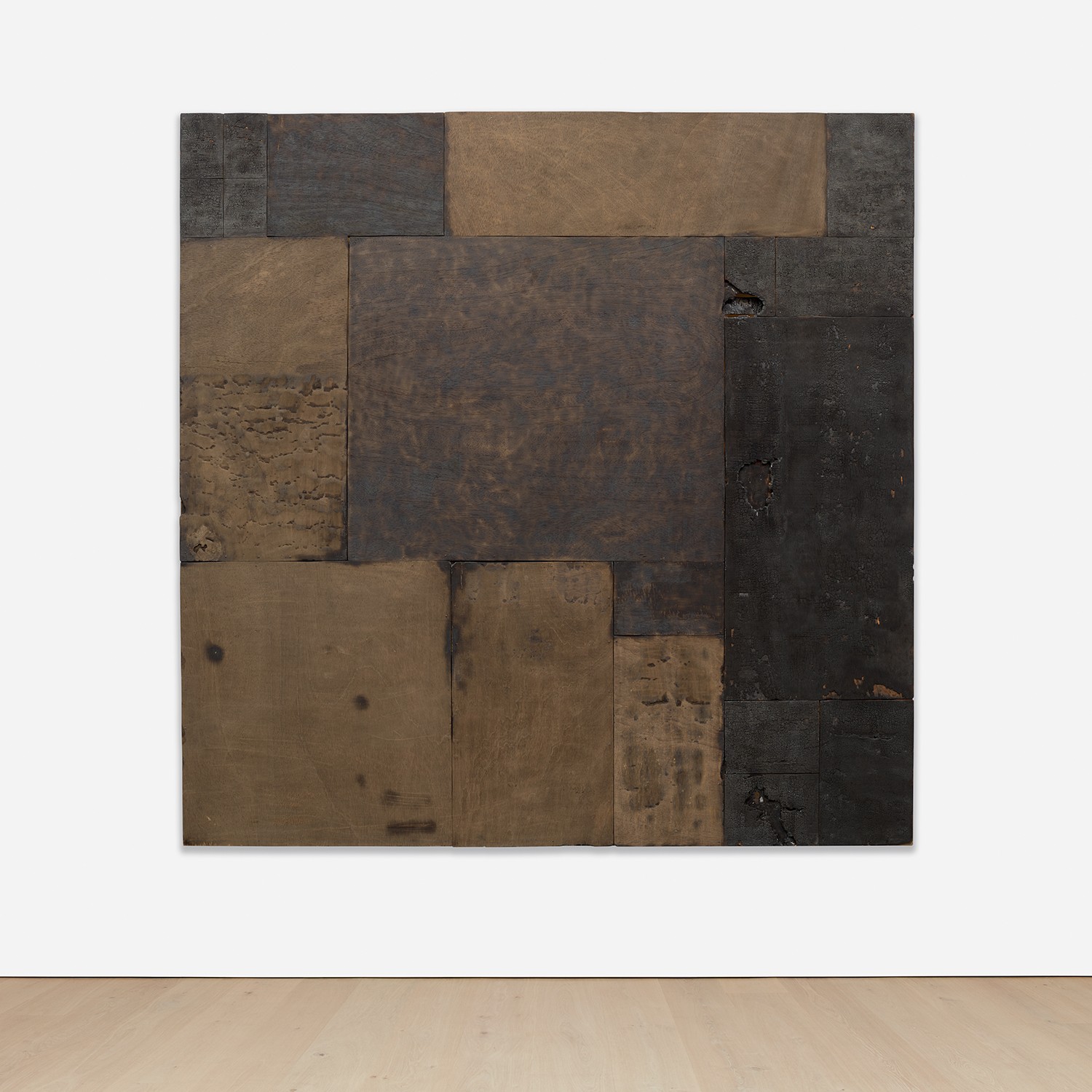 burnt wood and nails on wooden stretcher