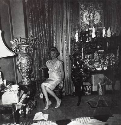 Elizabeth Taylor look-alike reclining on a bed, London, England