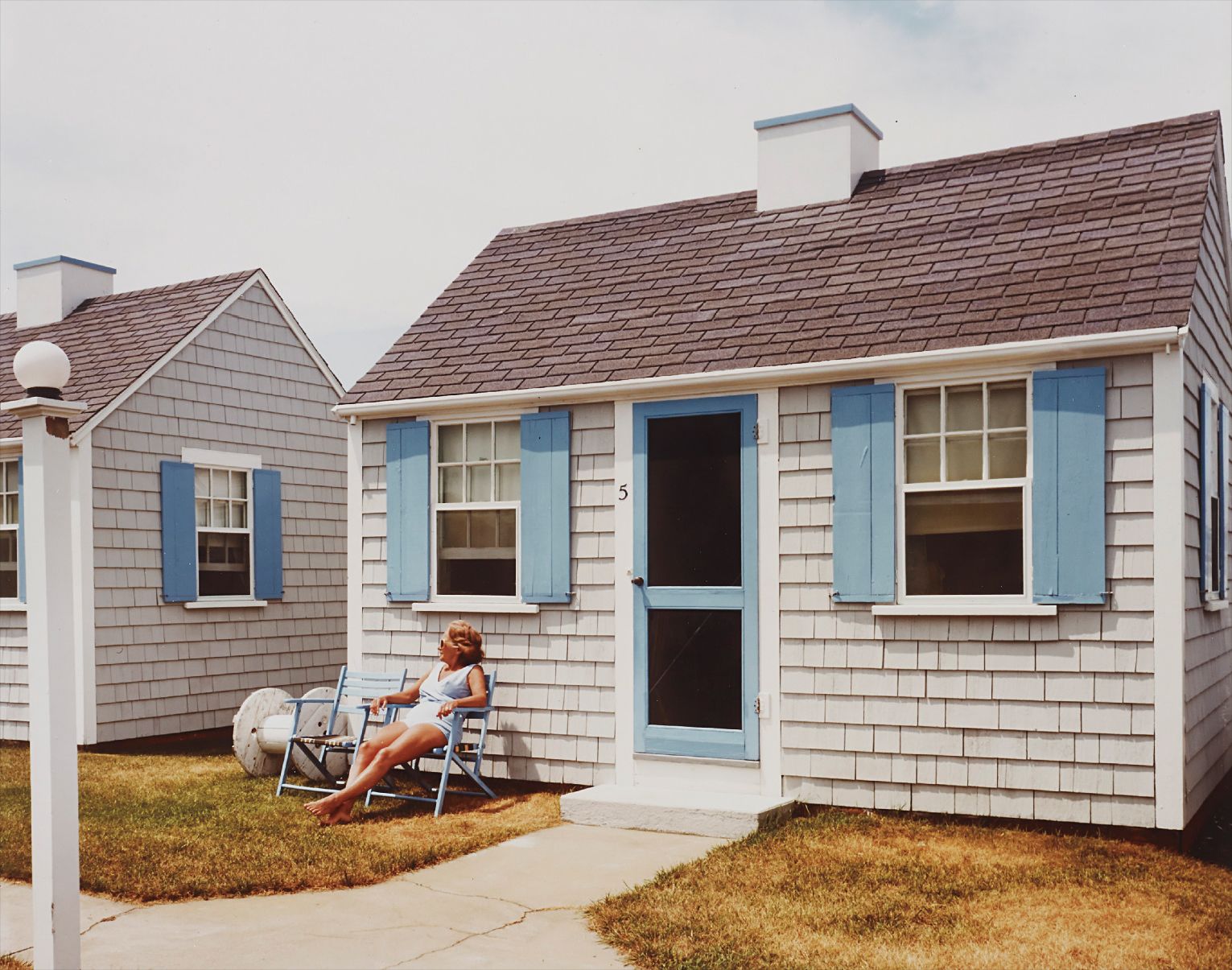 Joel Meyerowitz — Woman in blue and sunlight, Provincetown