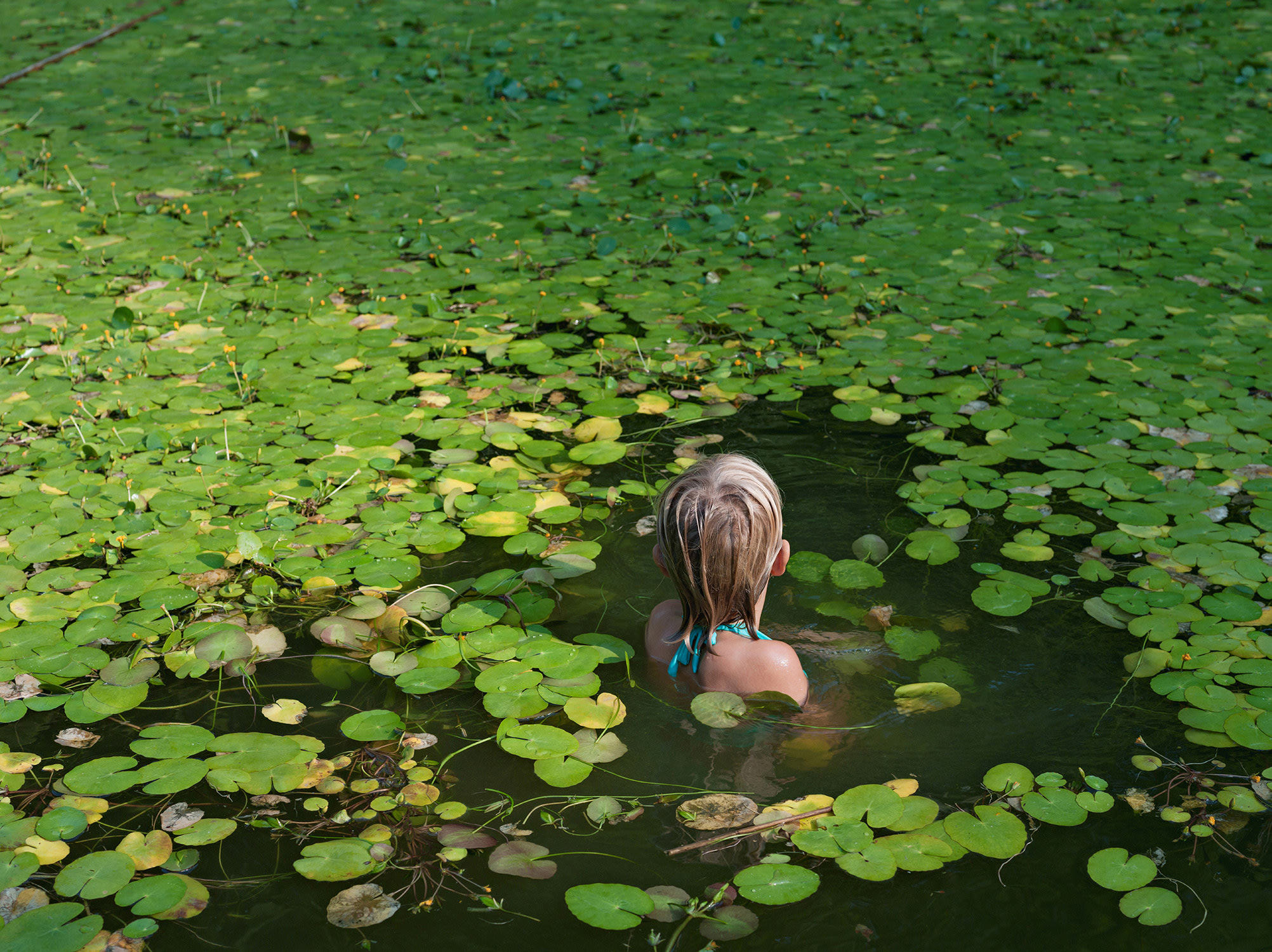 Lucas Foglia — Maddie with Water Lilies, North Carolina from Human Nature