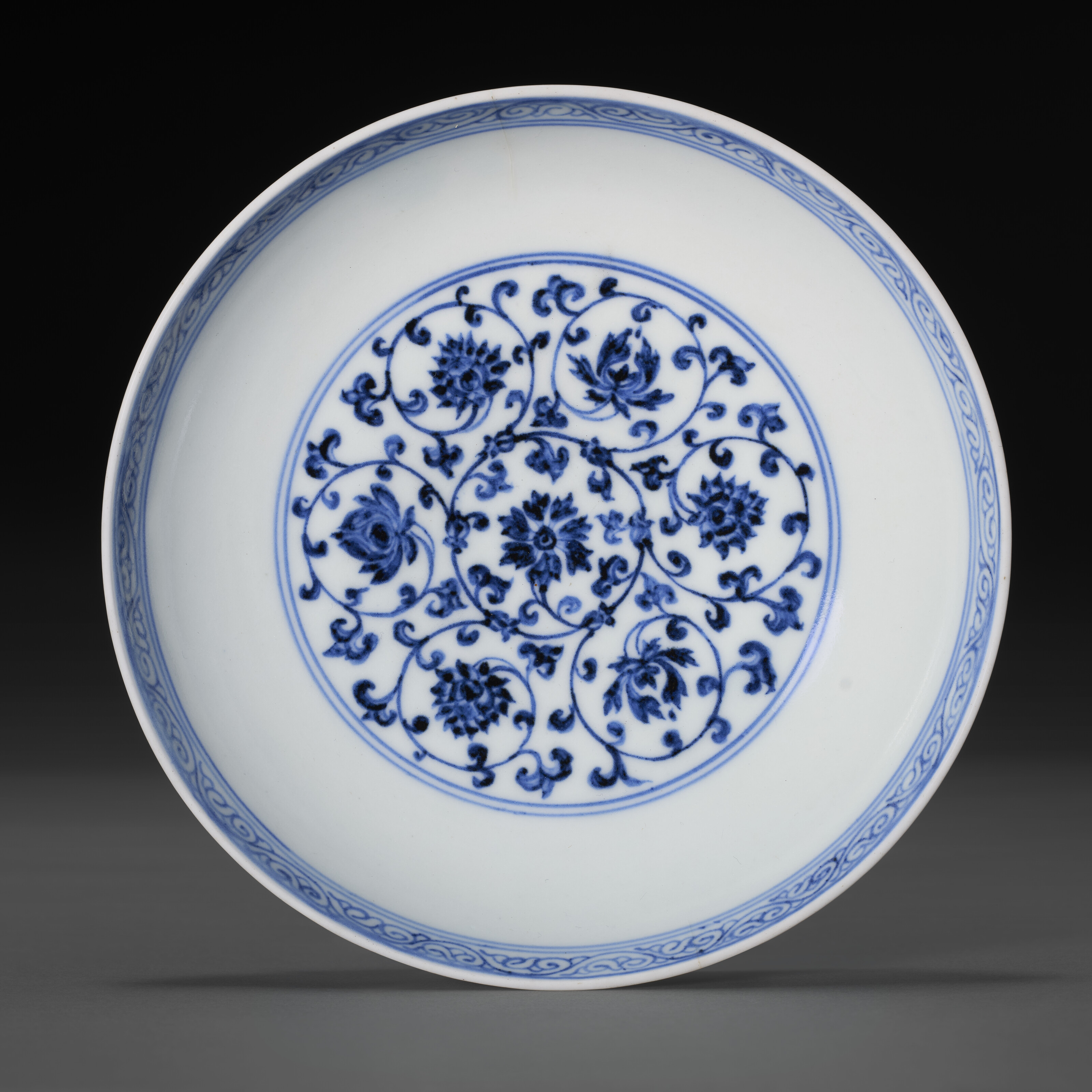 A Very Rare Blue And White 'floral Scroll' Dish — XUANDE SIX-CHARACTER MARK IN UNDERGLAZE BLUE WITHIN A DOUBLE CIRCLE AND OF THE PERIOD (1426-1435)