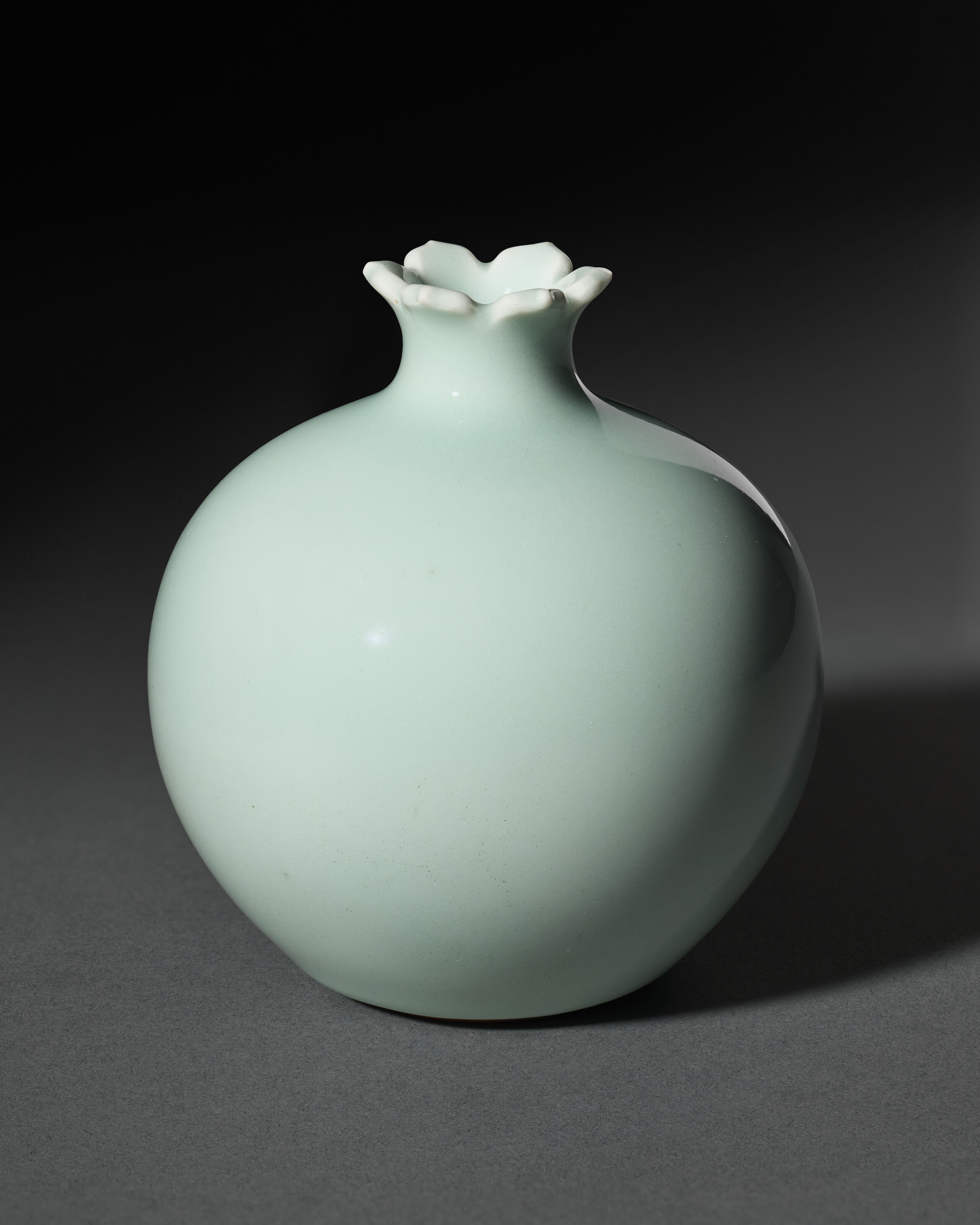 A Very Rare Small Celadon-glazed Pomegranate-form Vase — QIANLONG SEAL MARK IN UNDERGLAZE BLUE AND OF THE PERIOD (1736-1795)