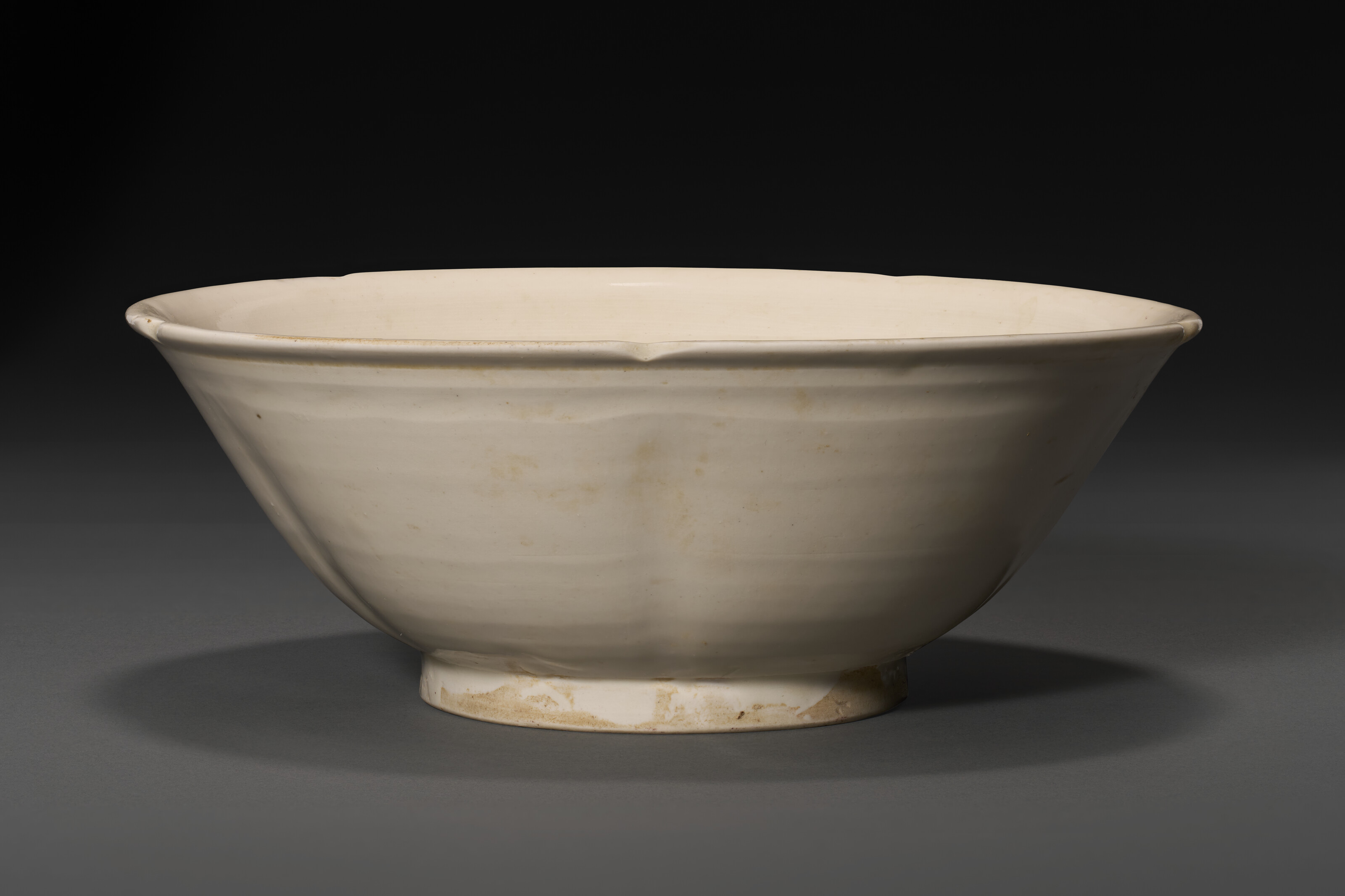 A Xing White-glazed Lobed Bowl — 10TH CENTURY