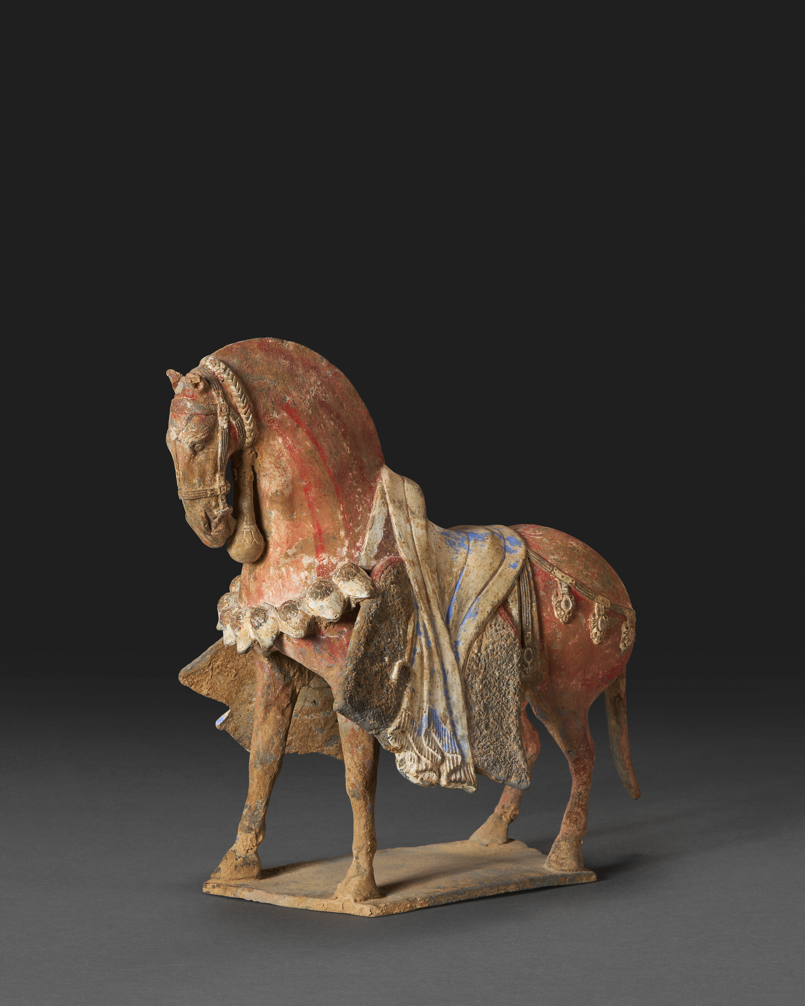 A Finely Modeled Painted Grey Pottery Figure Of A Caparisoned Horse — NORTHERN WEI DYNASTY (AD 386-534)