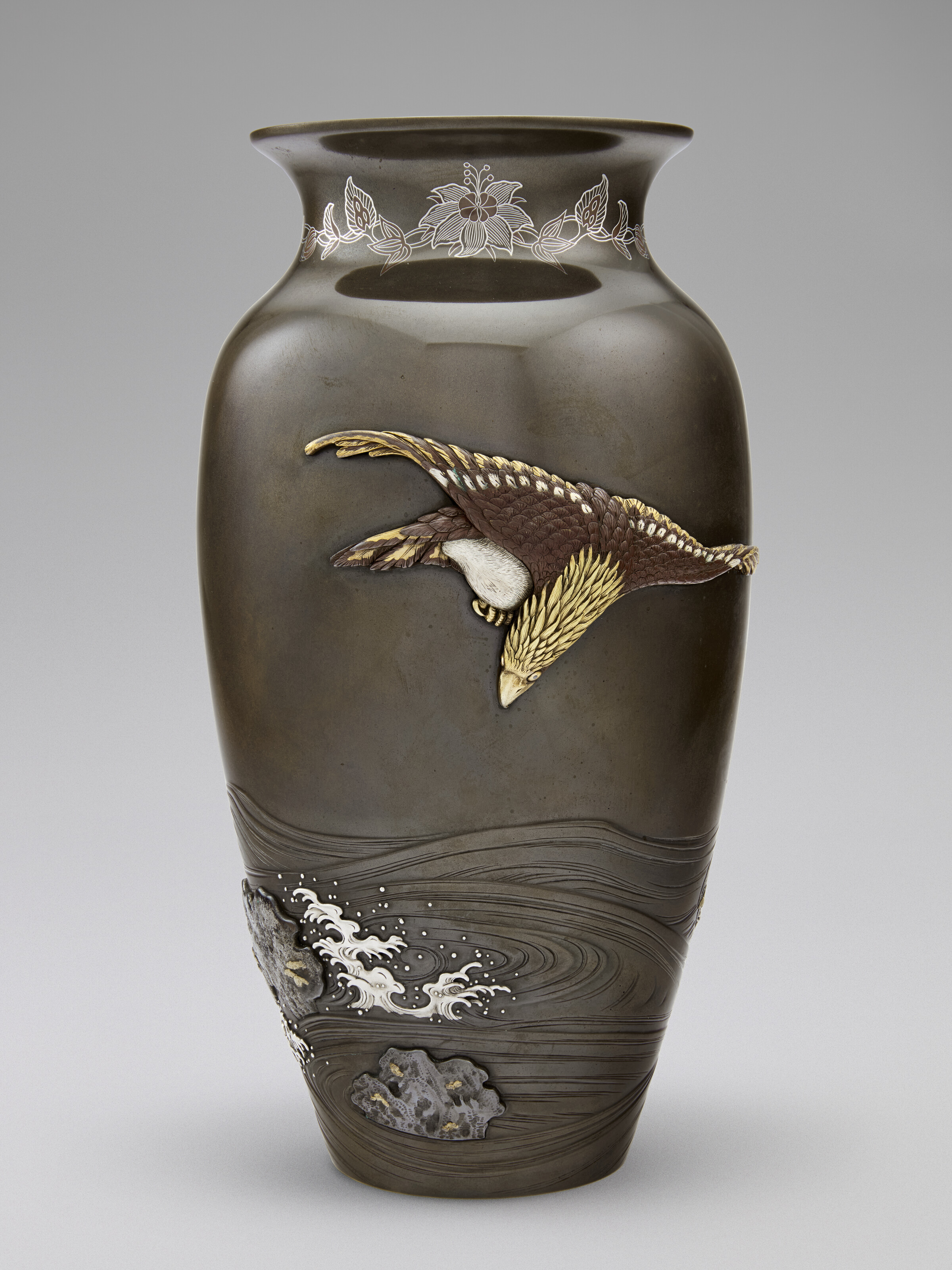 A Soft-metal-inlaid Shibuichi Vase With Hawk Flying Over Waves — MEIJI PERIOD (LATE 19TH CENTURY), WITH A DOUBLE-MOUNTAIN MARK (KIRYU KOSHO KAISHA) AND SEALED KAKO (SUZUKI CHOKICHI; 1848-1919)
