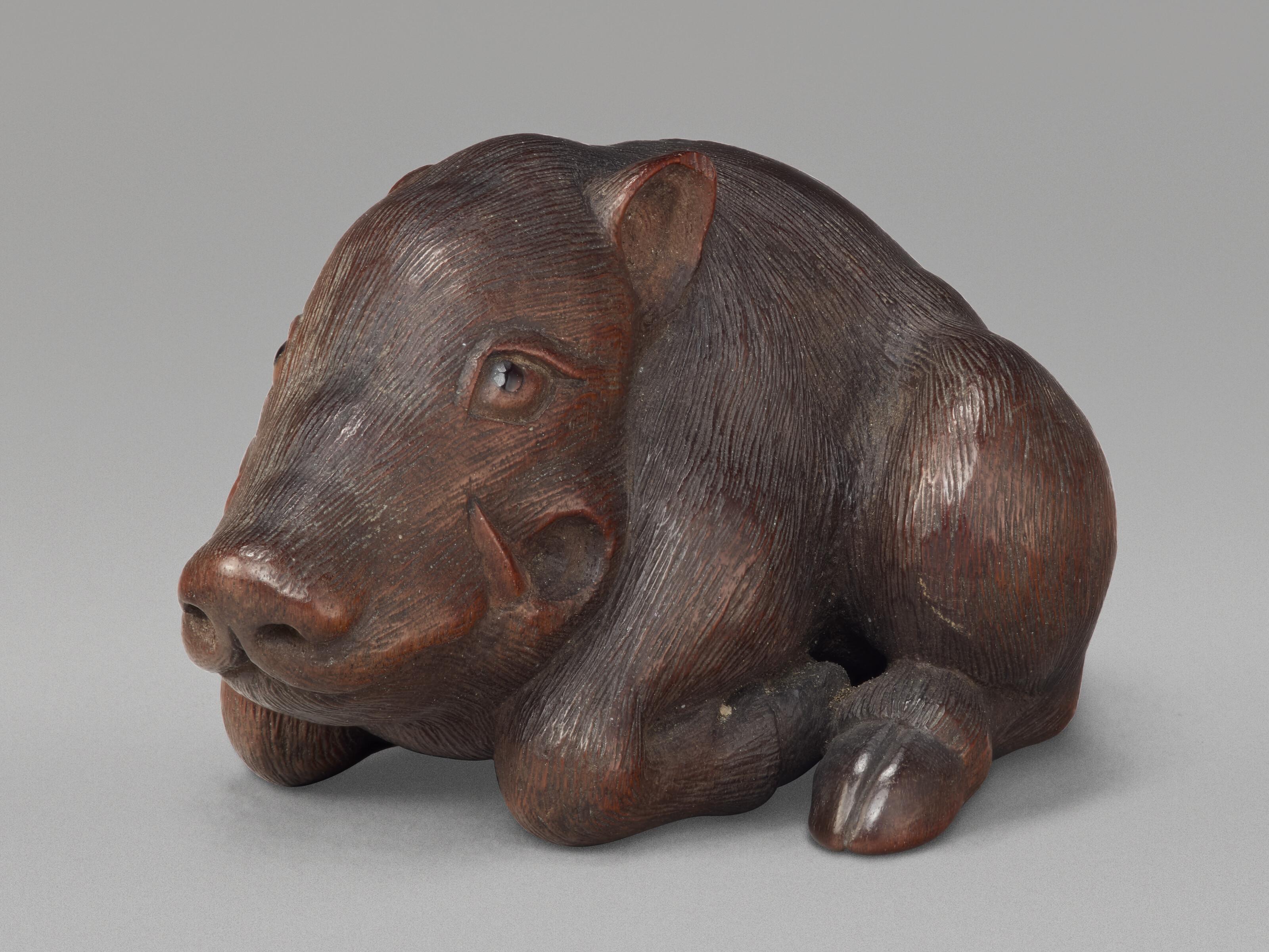 A Carved Wood Netsuke Miniature Sculpture Of A Boar — EDO PERIOD (19TH CENTURY), SIGNED KUMU